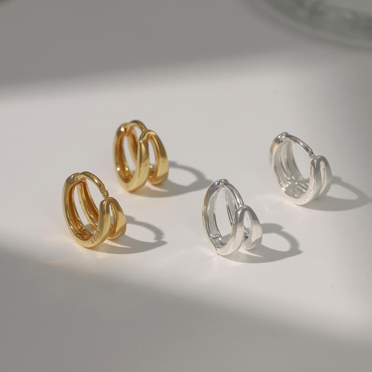 small hoop earrings available in gold and silver finishes, v-shaped double huggie earrings
