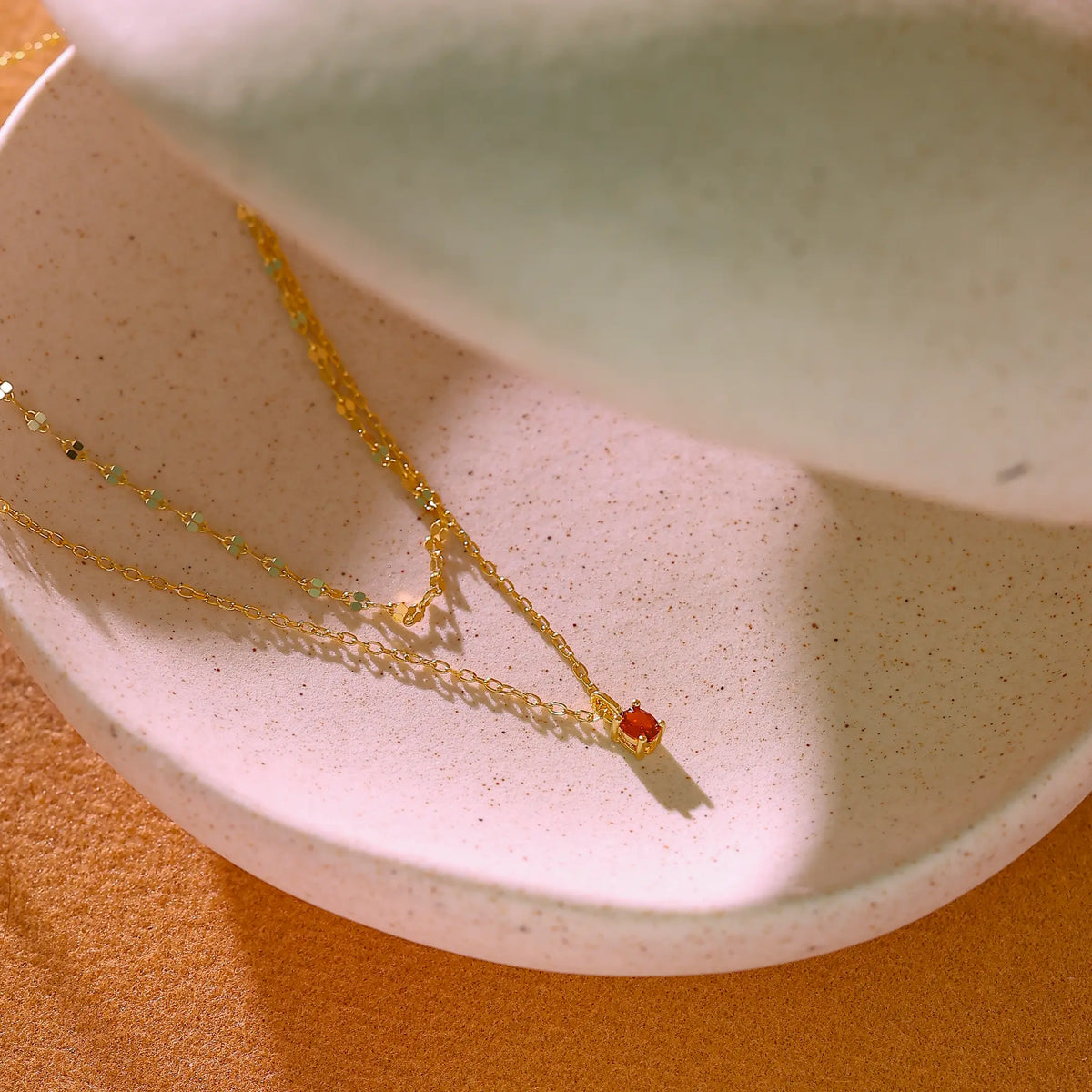Double strand 925 sterling silver necklace with 14K gold coating and cubic zirconia ruby.