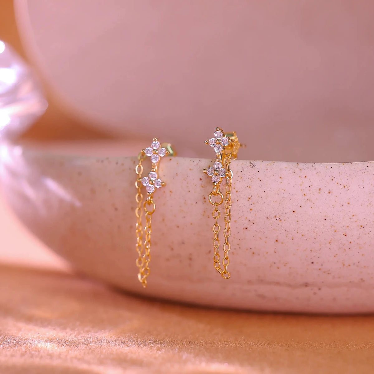 14K gold plated sterling silver earrings featuring a crystal flower stud and long chain drop.