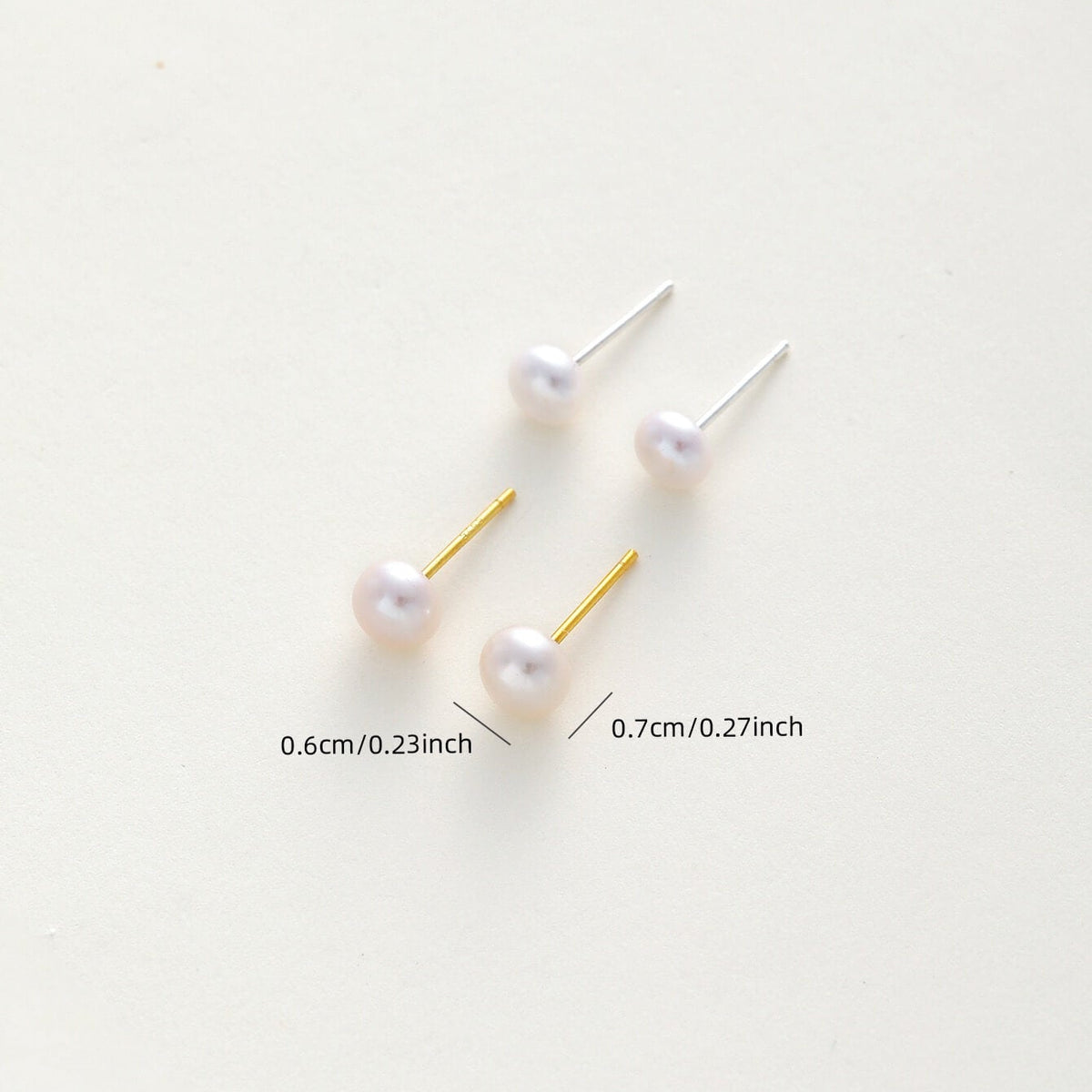 pearl stud earrings with gold and silver posts on a light cream background, with size measurements printed below.