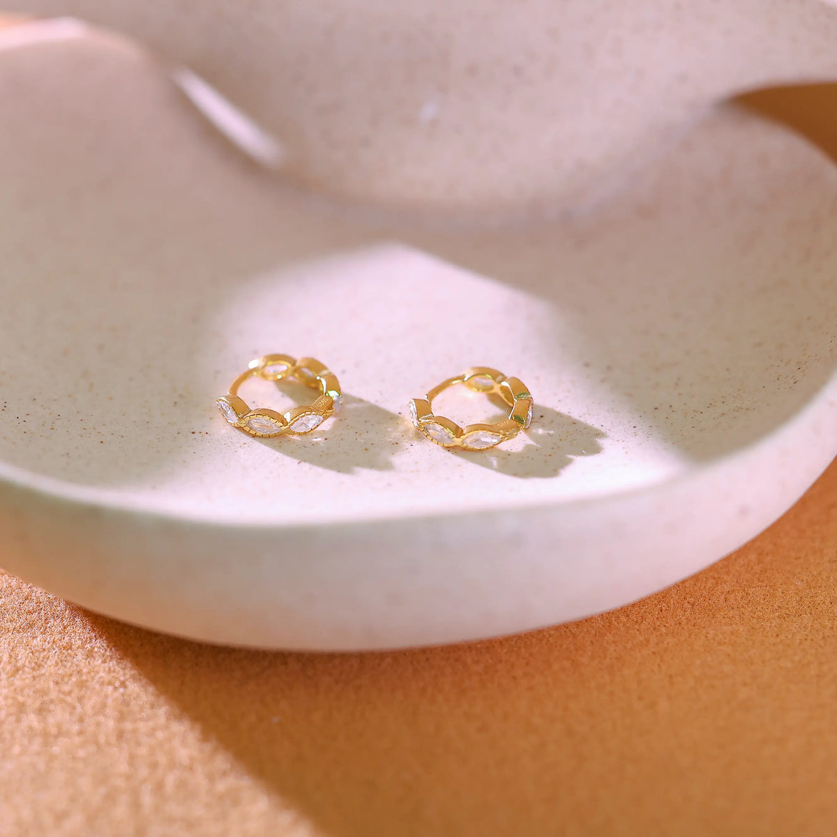 925 sterling silver hoops featuring a seamless row of marquise cut clear crystals