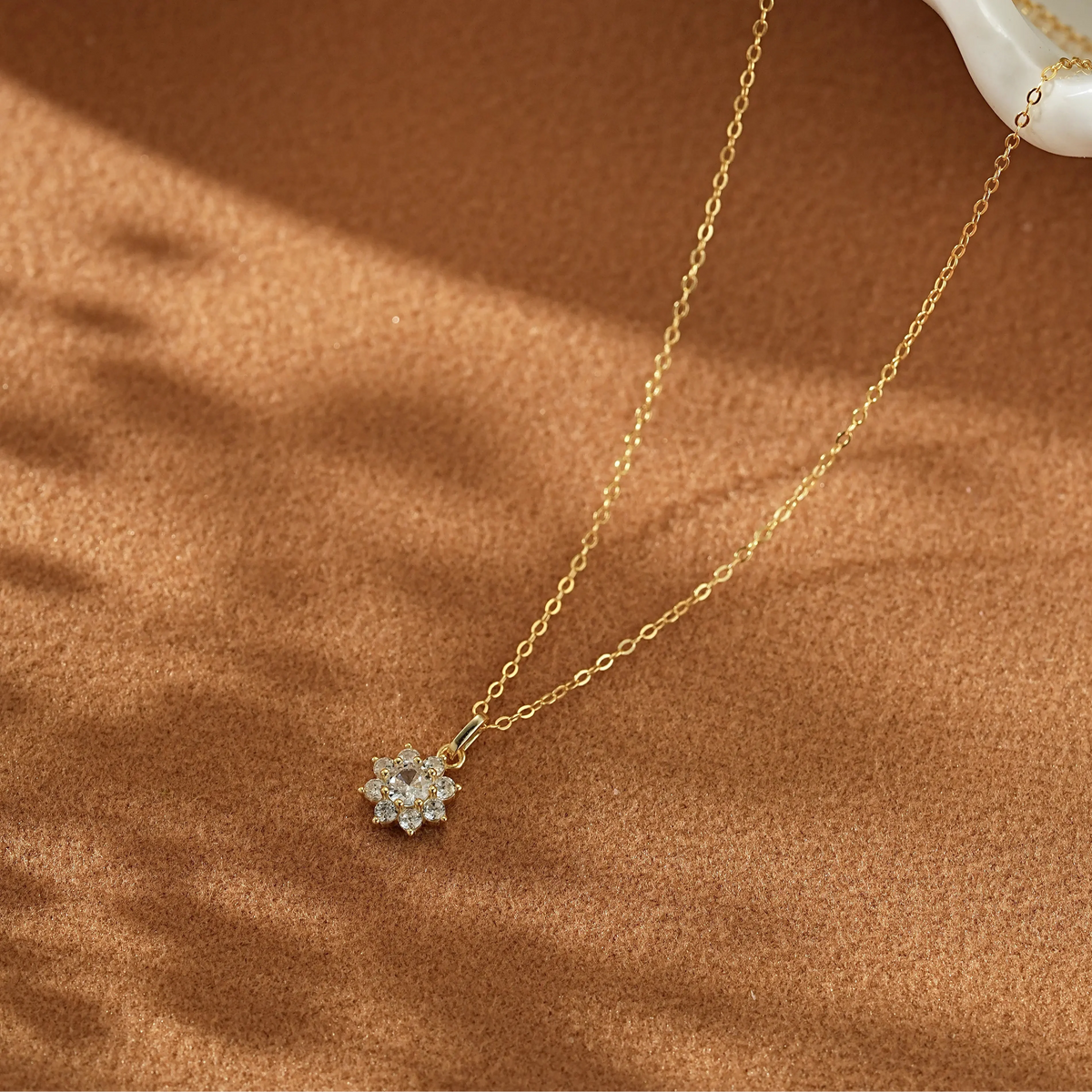 14K gold plated 925 sterling silver snowflake necklace with CZ diamonds on a clean white background.