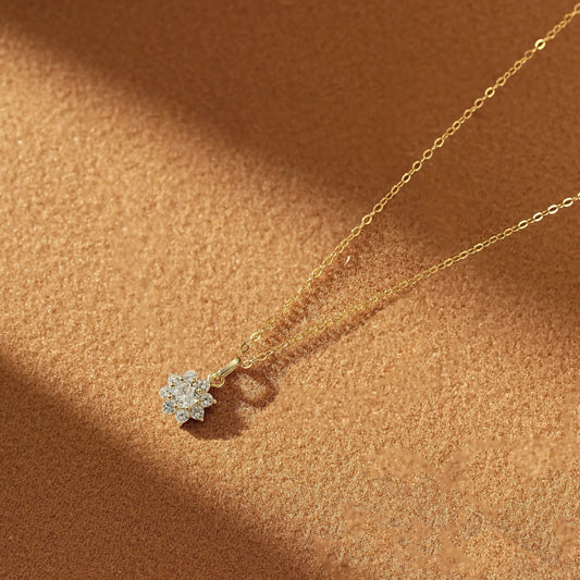 Detailed view of the gold chain with the diamond snowflake pendant