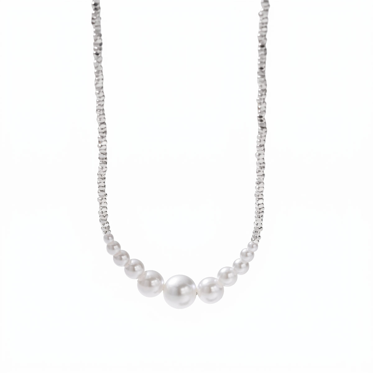 Minimalist round pearl bead necklace resting on a fine silver chain.