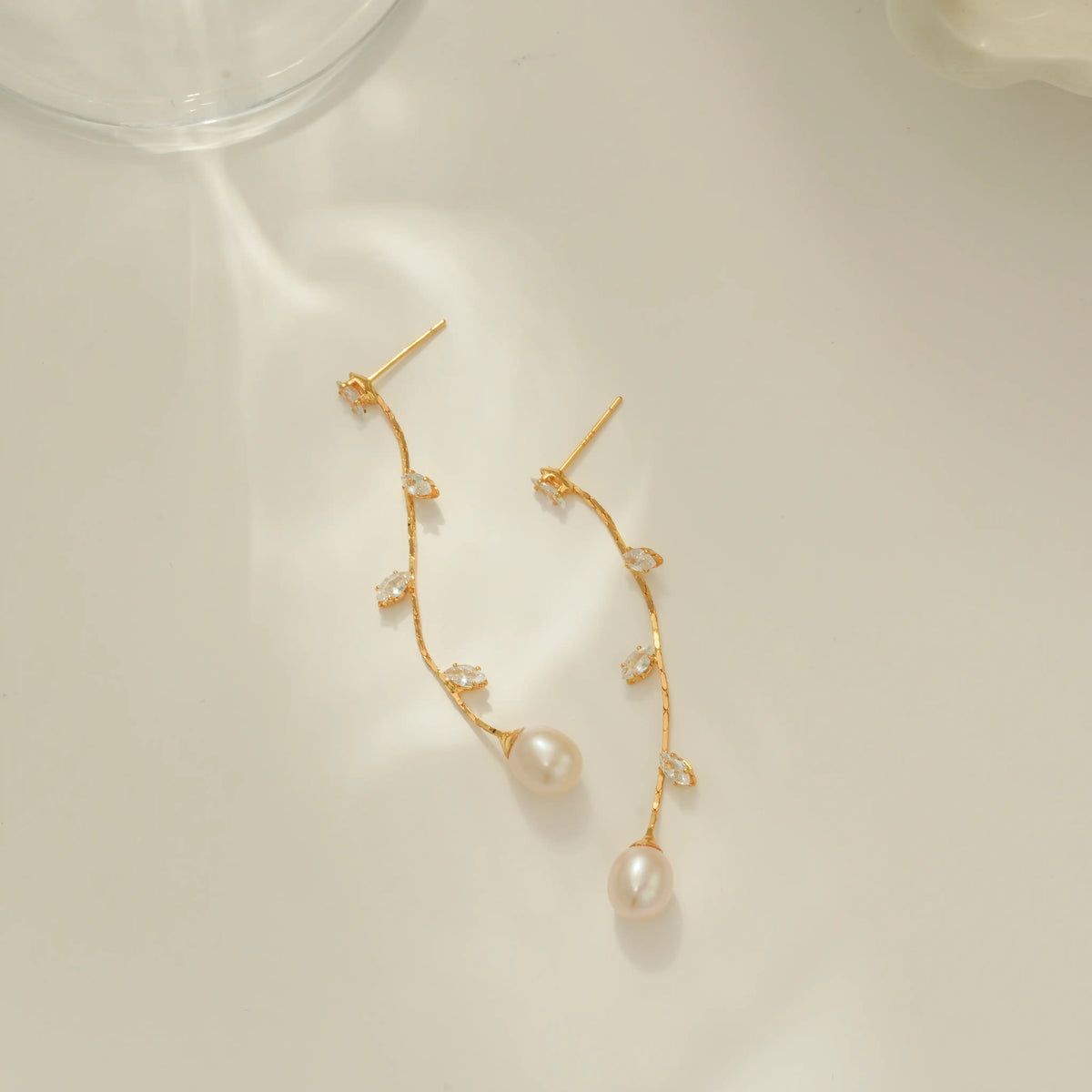 Long pearl and CZ leaf drop earrings with gold finish