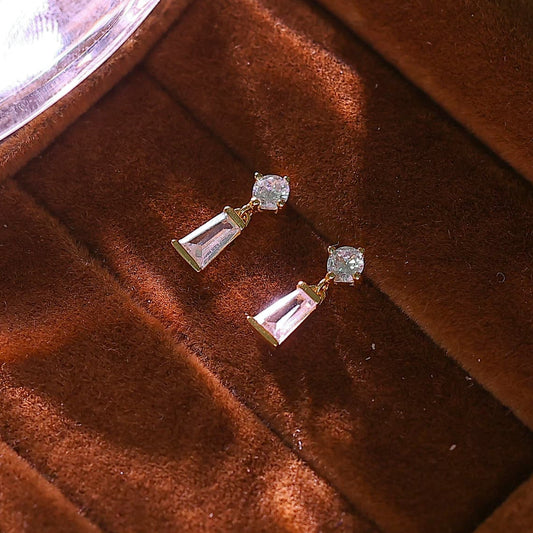 Macro shot of the rectangular baguette cut cubic zirconia hanging from a round crystal stud.